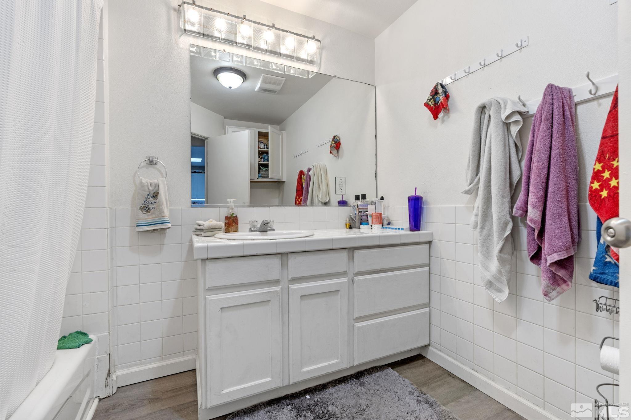 1855 Desna Street Reno, NV 89512 - Photo 16 of 35 a bathroom with a sink mirror and vanity