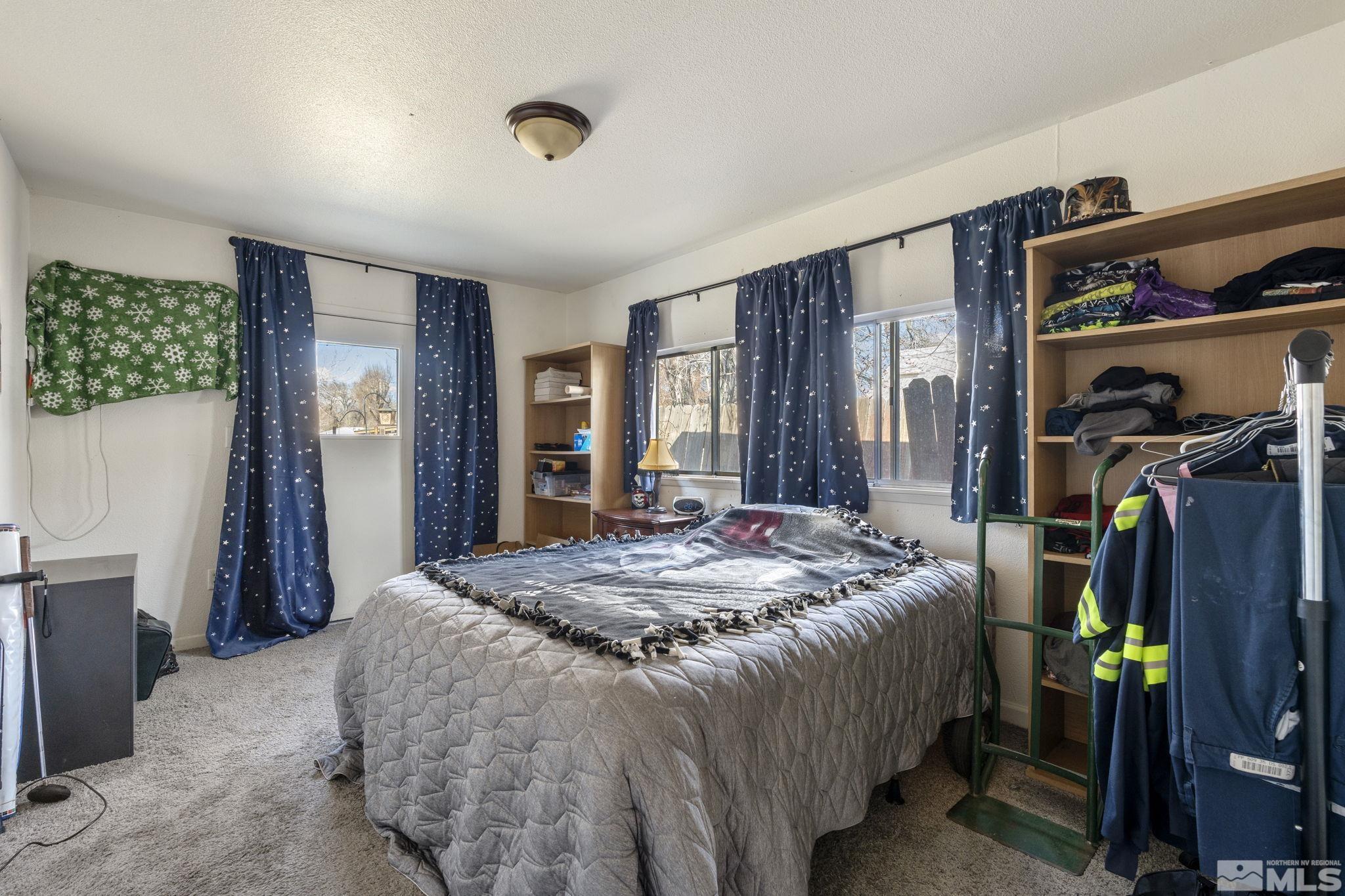 1855 Desna Street Reno, NV 89512 - Photo 21 of 35 a bed sitting in a bedroom next to a window