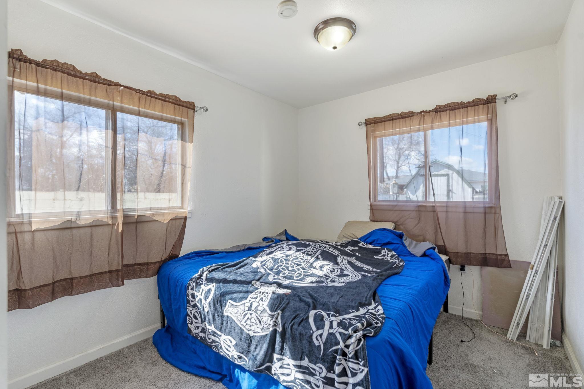 1855 Desna Street Reno, NV 89512 - Photo 23 of 35 a bedroom with a bed and a large window