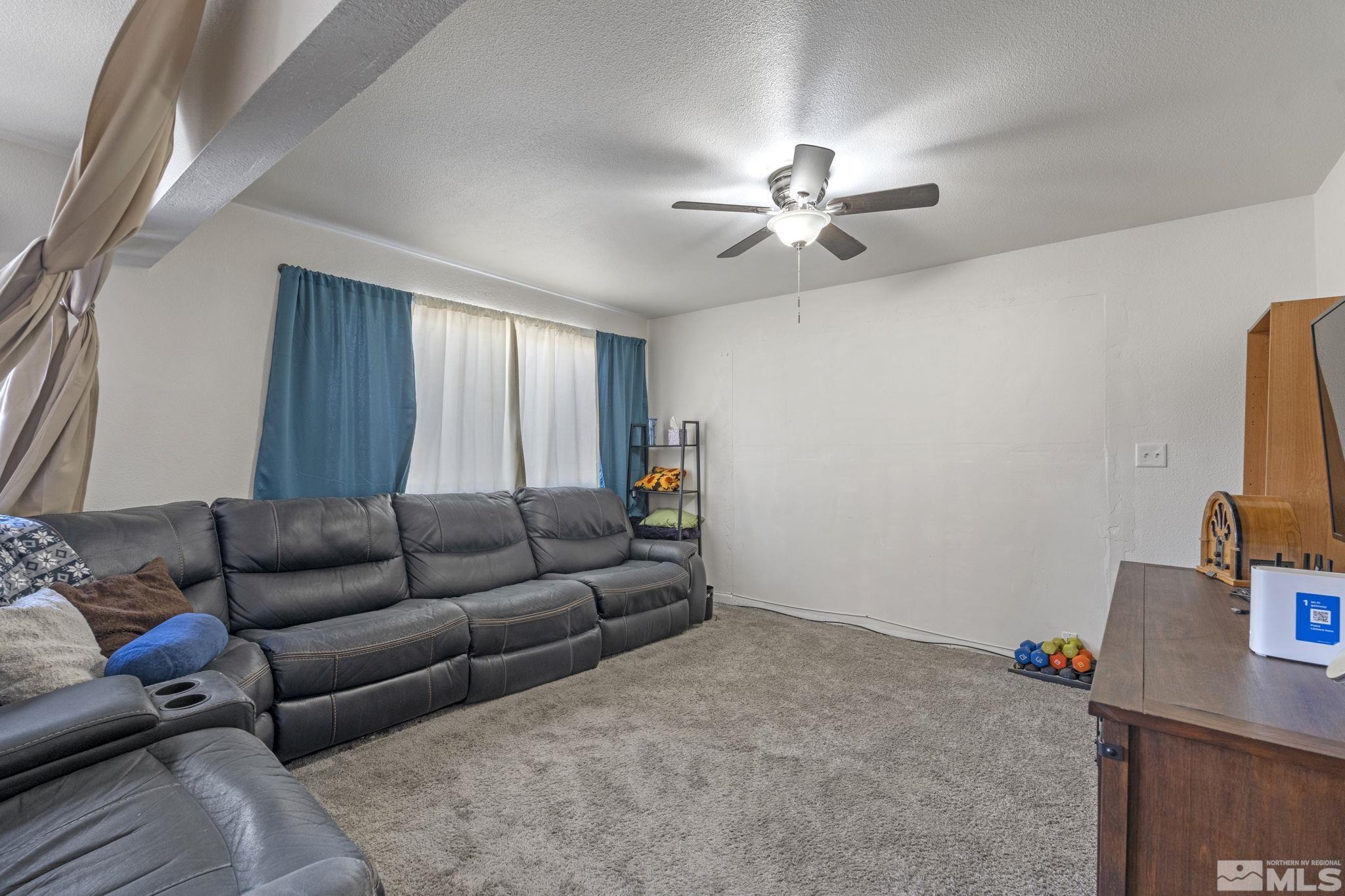 1855 Desna Street Reno, NV 89512 - Photo 26 of 35 a living room with furniture and a flat screen tv