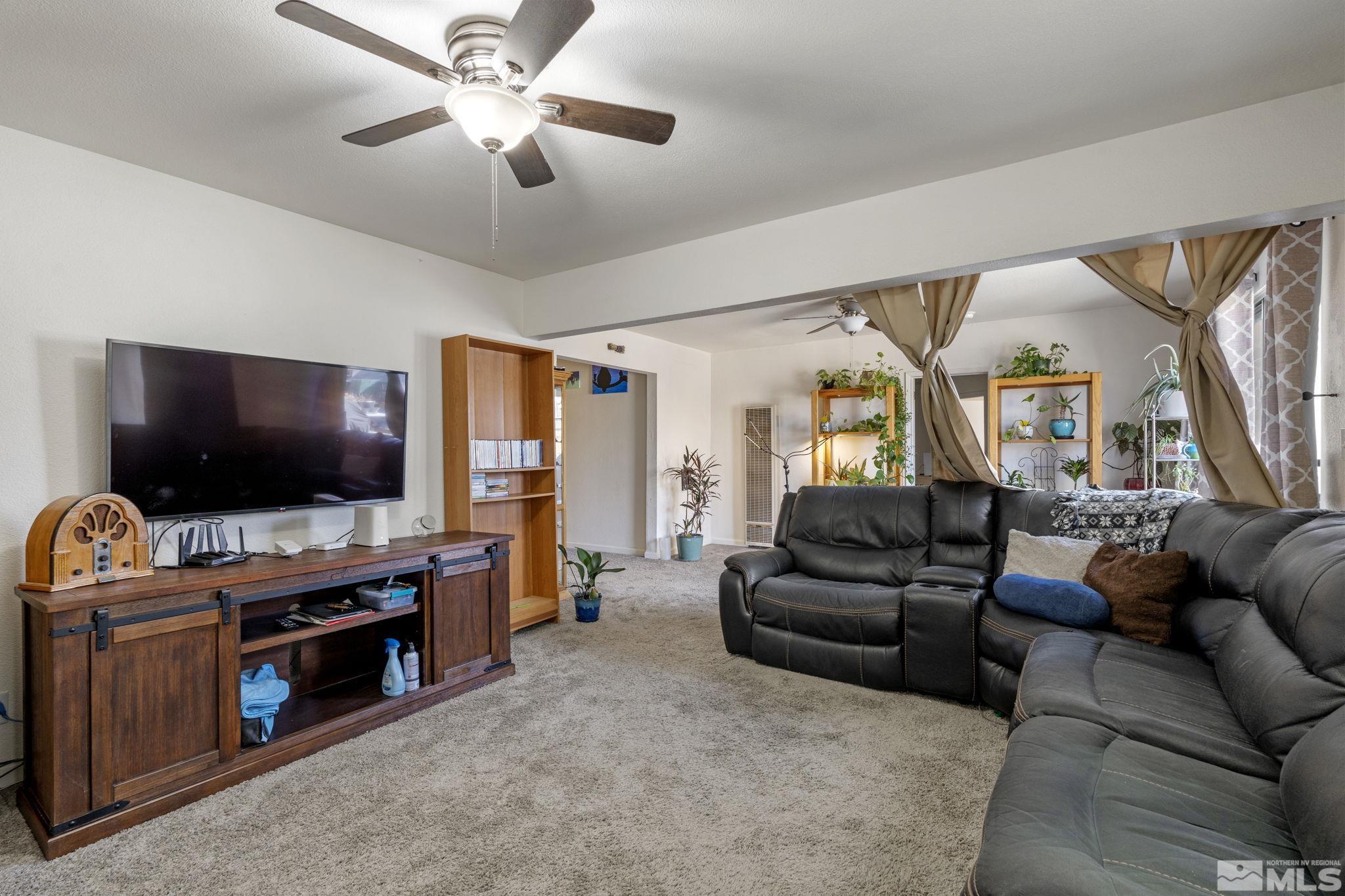 1855 Desna Street Reno, NV 89512 - Photo 29 of 35 a living room with furniture and a flat screen tv