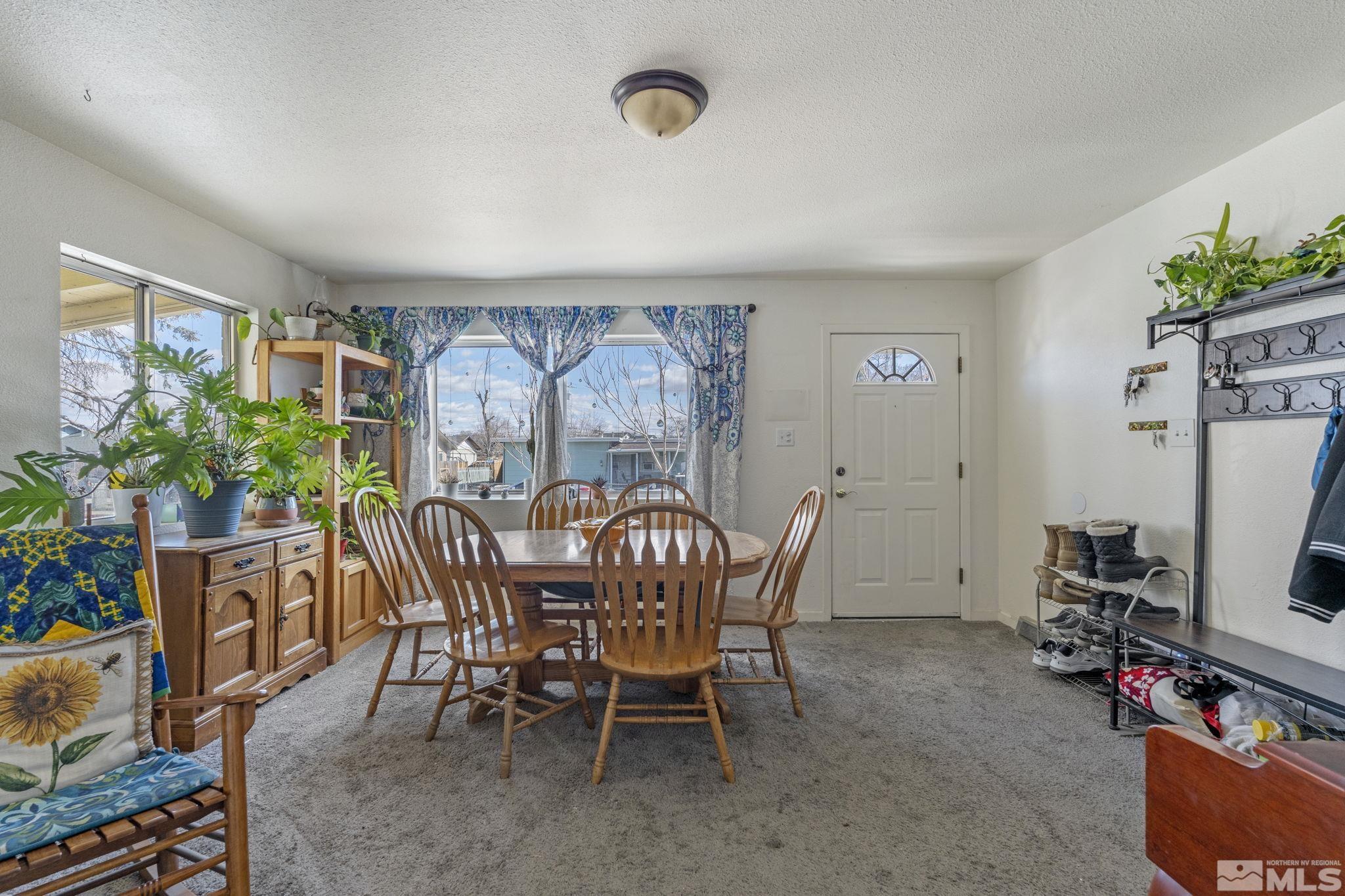 1855 Desna Street Reno, NV 89512 - Photo 4 of 35 a view of a dining room with furniture and a potted plant