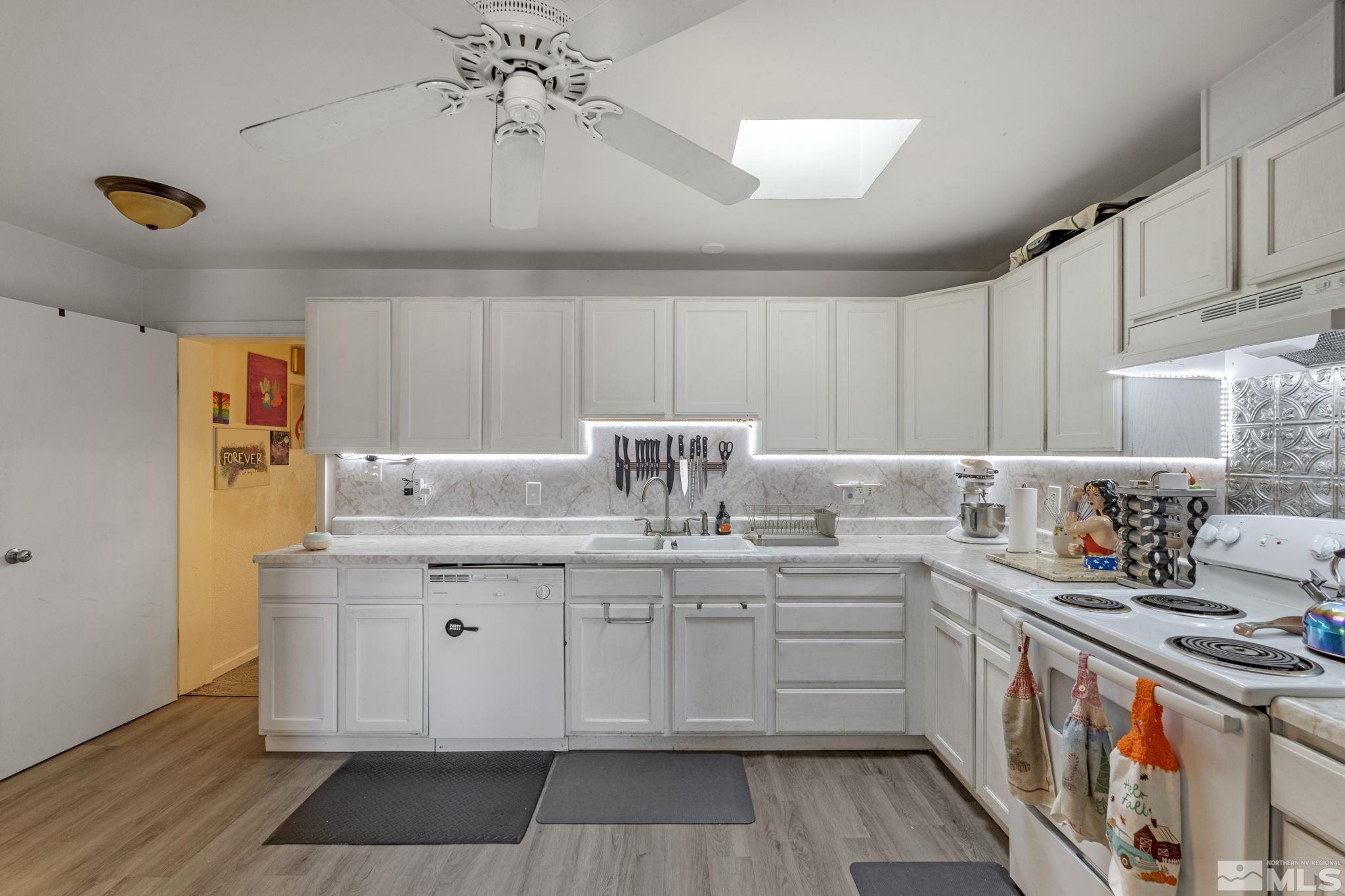 1855 Desna Street Reno, NV 89512 - Photo 6 of 35 a kitchen with stainless steel appliances a sink stove and cabinets