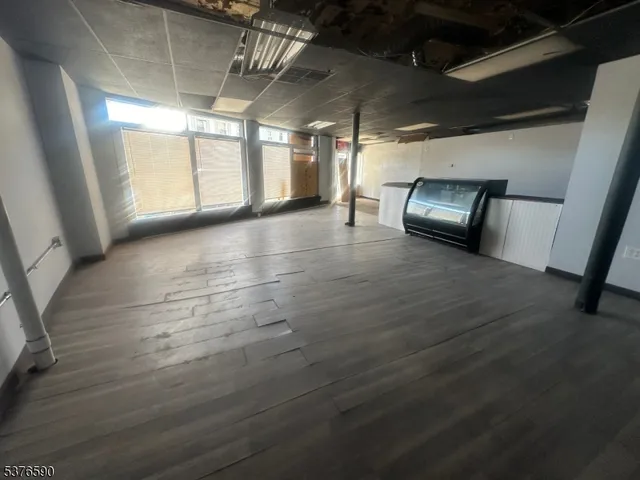 a view of a water heater room with wooden floor
