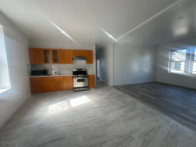 a view of kitchen and kitchen with furniture large window and wooden floor
