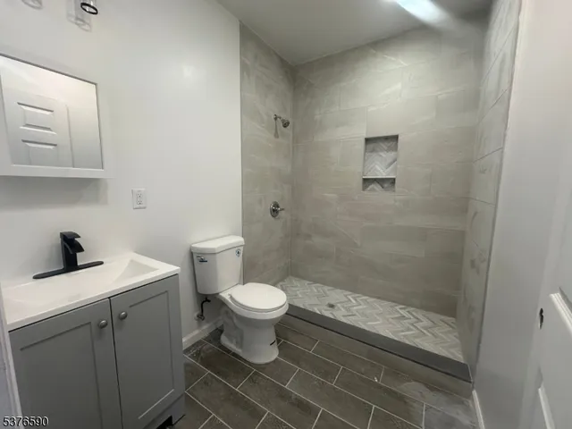 a bathroom with a bathtub a sink a toilet and a shower