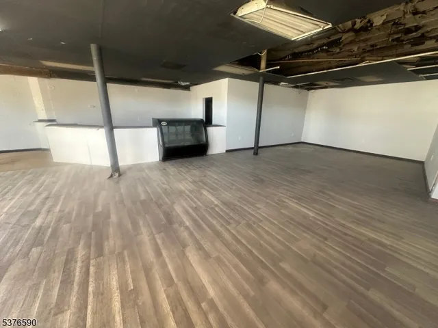 a view of a room with wooden floor