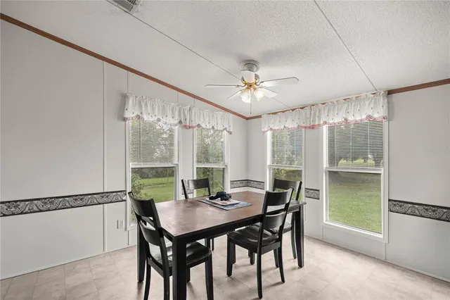 a view of a dining room with furniture window and outside view