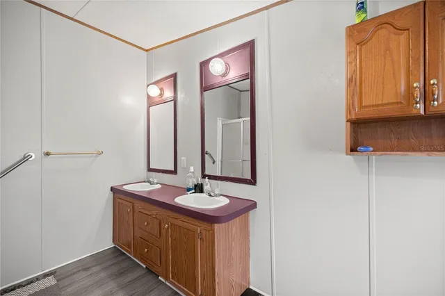 a bathroom with a sink a mirror and a vanity