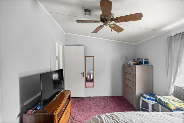a bedroom with furniture and a window