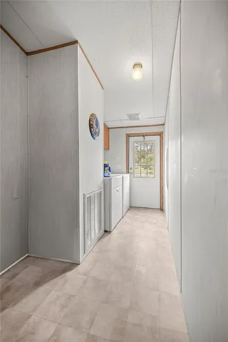 an aerial view of residential houses with outdoor space and trees all around