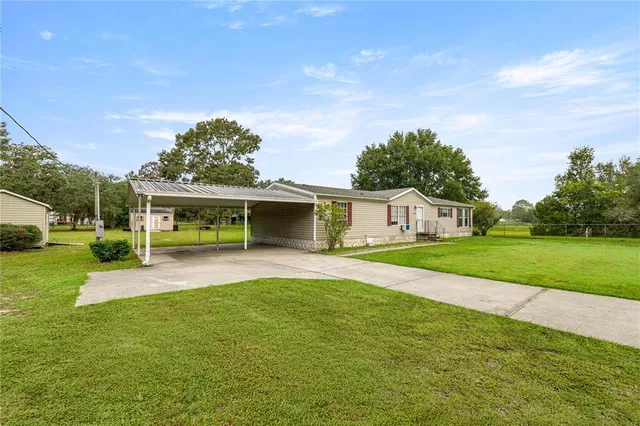 a front view of house with yard and green space