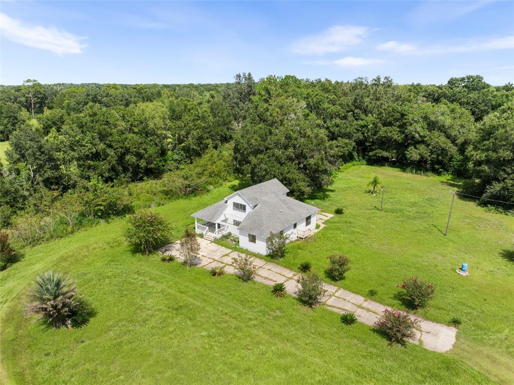 an aerial view of a house with a yard