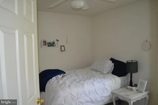 a bedroom with a bed and chair