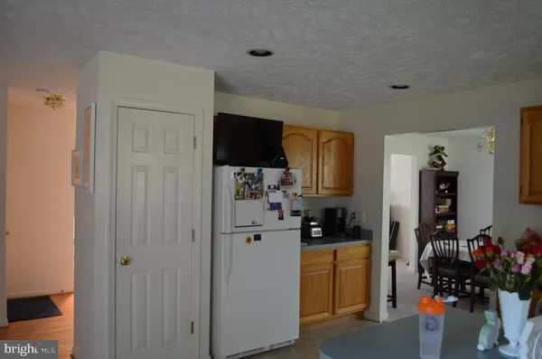 a kitchen with a refrigerator and a stove top oven