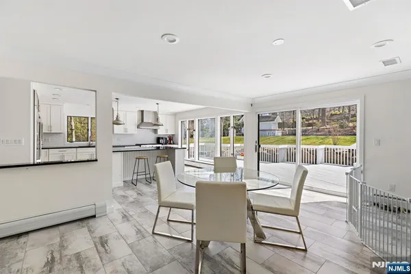 a dining room with furniture and large window