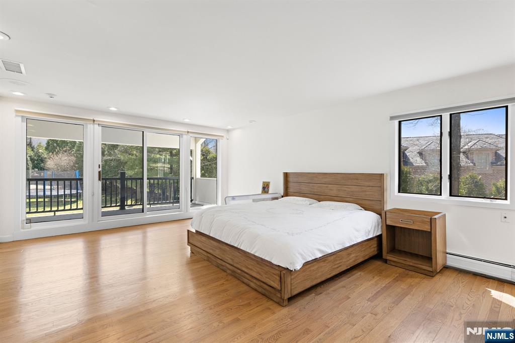 1 Hemlock Drive Cresskill, NJ 07626 - Photo 14 of 26 a large white bed sitting in a room next to a window