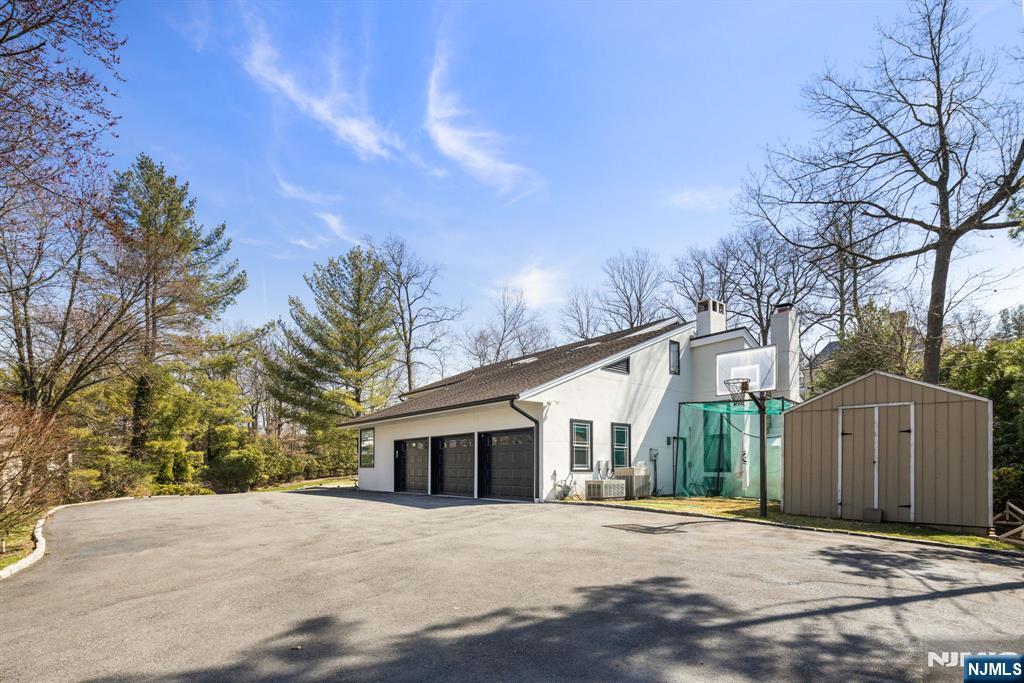 1 Hemlock Drive Cresskill, NJ 07626 - Photo 2 of 26 a front view of a house with a yard and garage