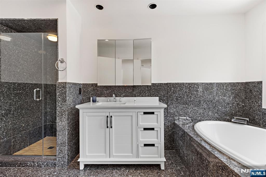 1 Hemlock Drive Cresskill, NJ 07626 - Photo 23 of 26 a bathroom with a granite countertop sink a toilet and mirror