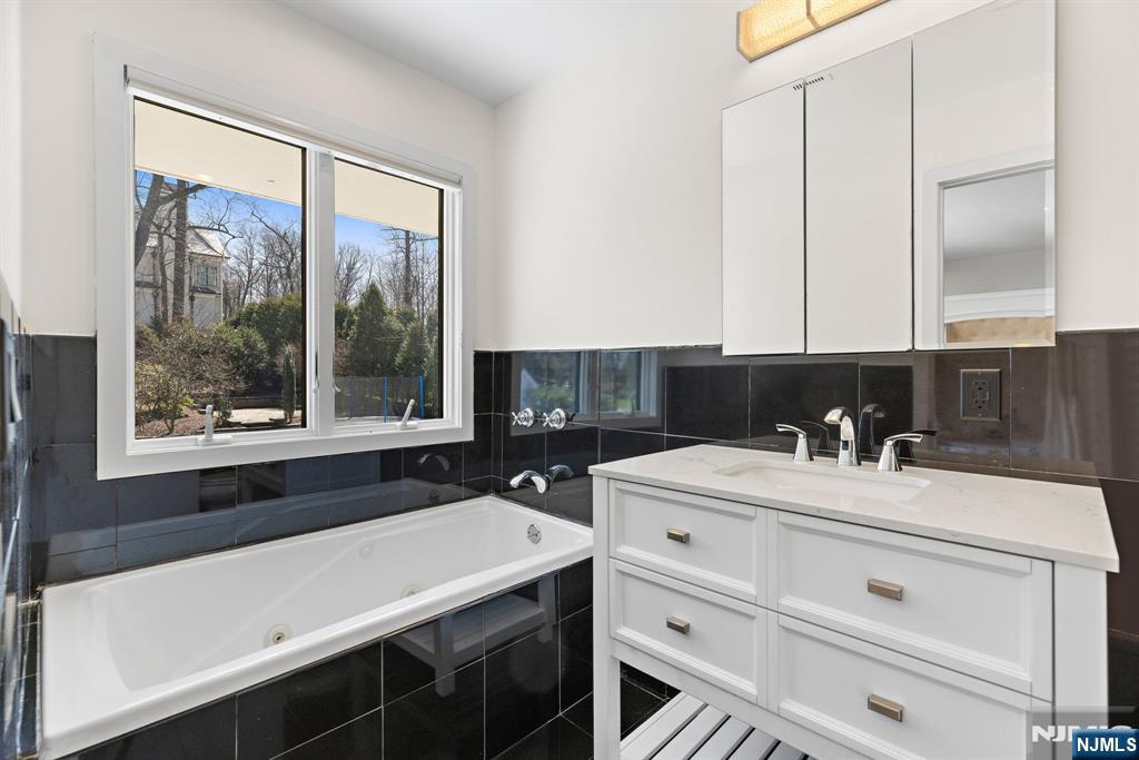 1 Hemlock Drive Cresskill, NJ 07626 - Photo 25 of 26 a bathroom with a sink and a bathtub