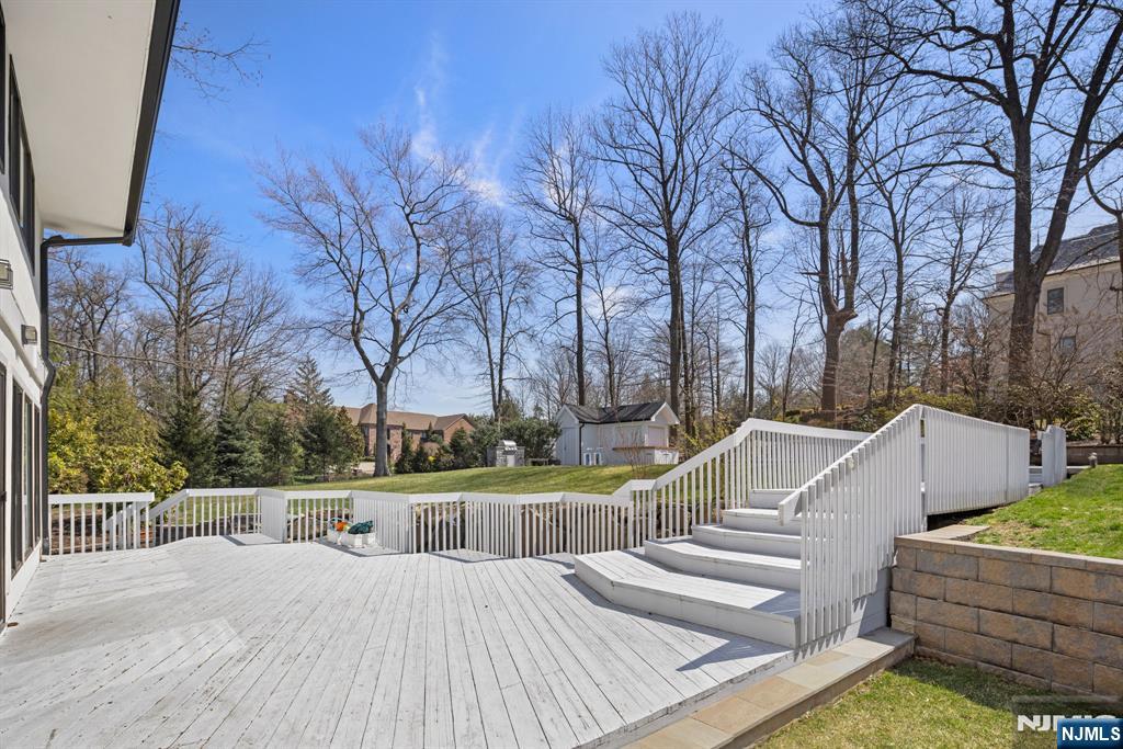 1 Hemlock Drive Cresskill, NJ 07626 - Photo 4 of 26 a view of a house with wooden deck and trees