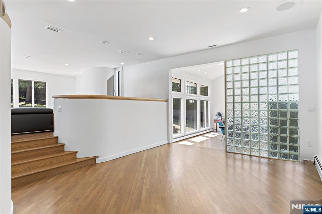 1 Hemlock Drive Cresskill, NJ 07626 - Photo 7 of 26 a view of an empty room with wooden floor and a window