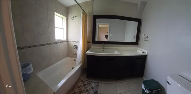a bathroom with a sink a toilet and bathtub
