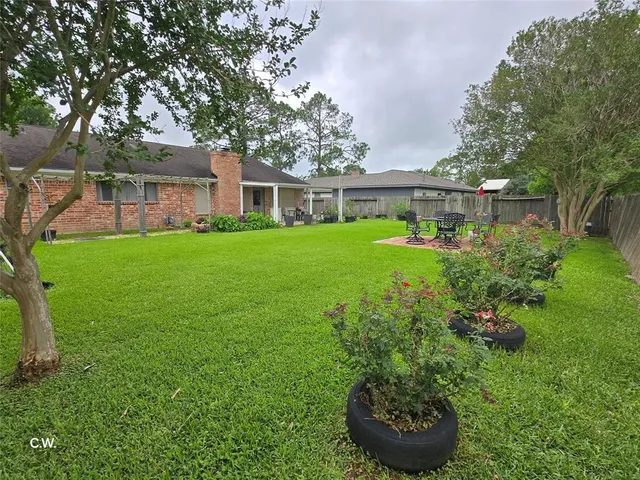 a view of a house with backyard sitting area and garden