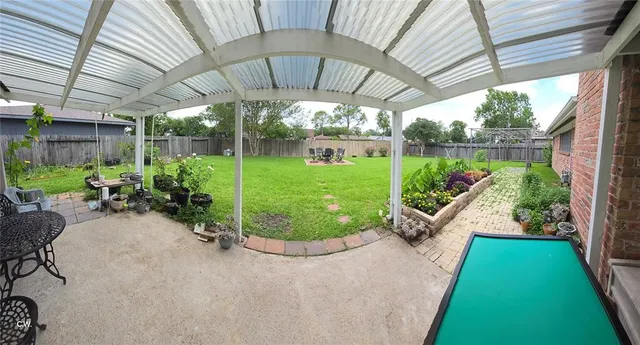 a view of a backyard with plants and a patio