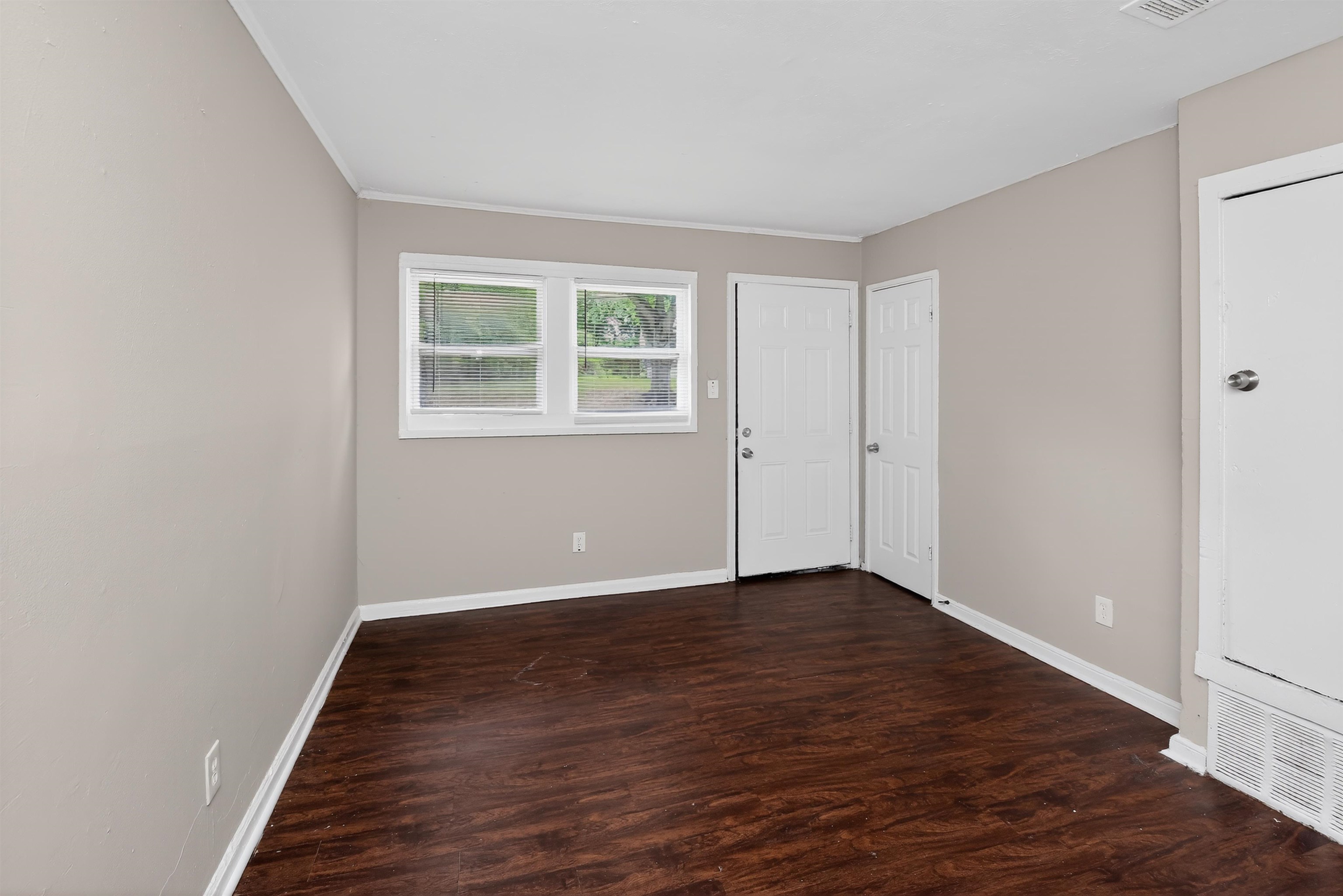 4838 Manson Road Memphis, TN 38109 - Photo 25 of 28 Interior room featuring wood-finish flooring, light neutral wall paint, and white trim