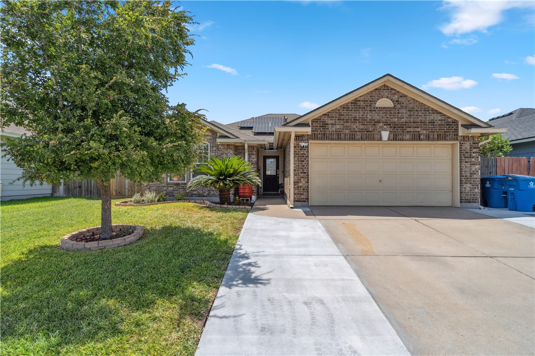 a front view of house with a garden