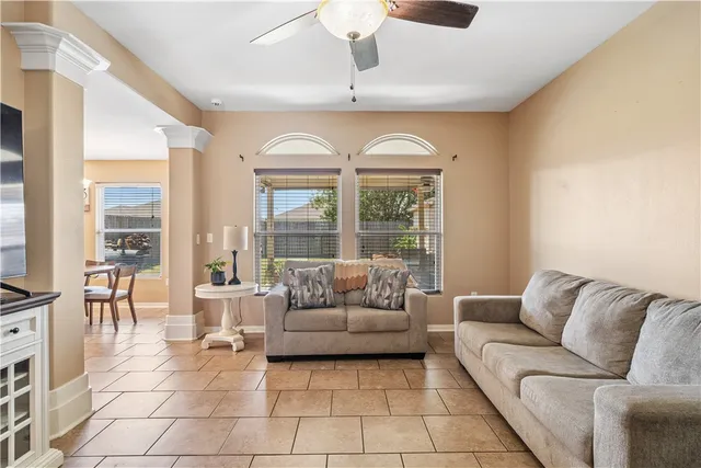 a living room with furniture and a large window