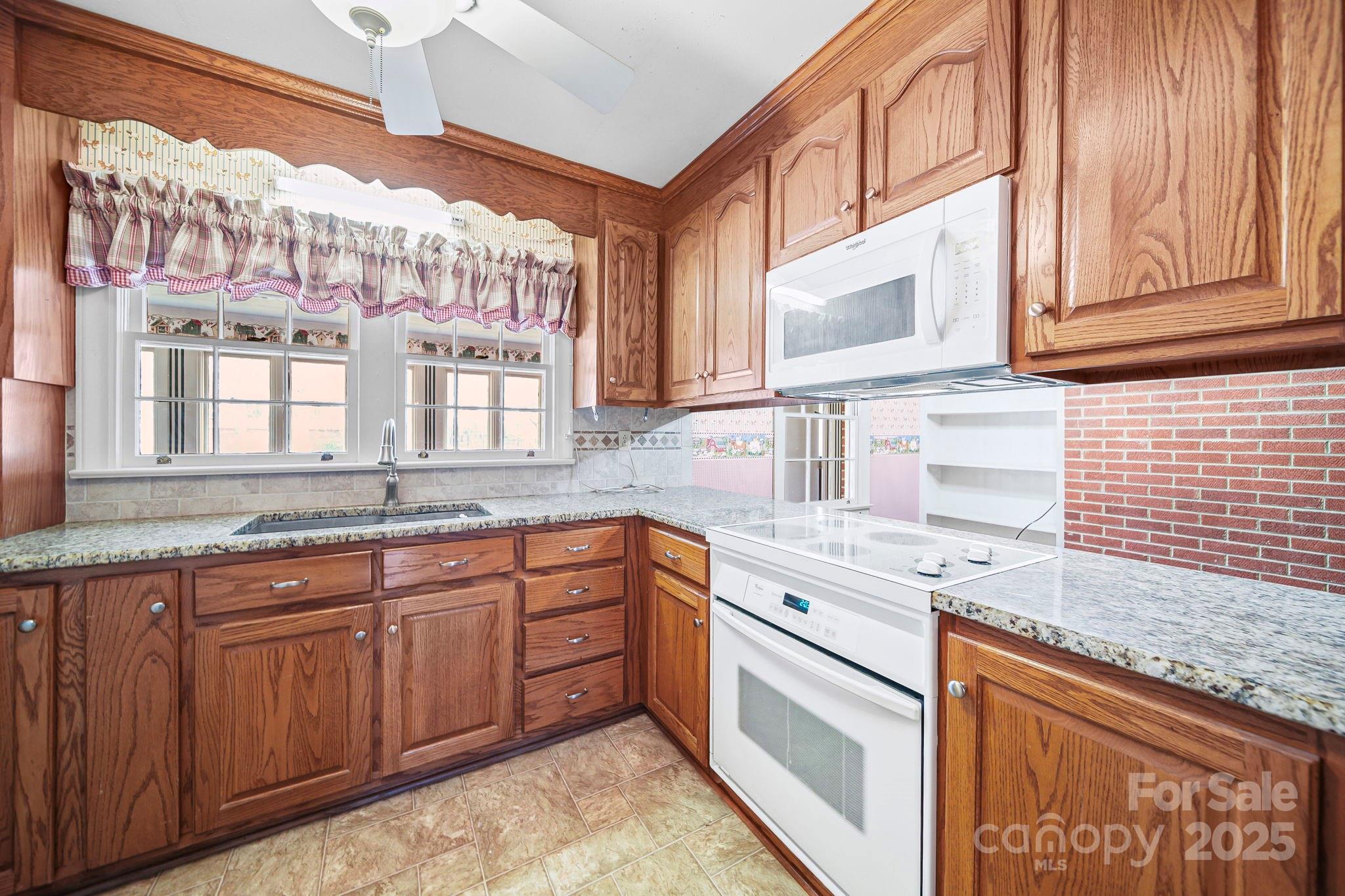 1223 Walker Road Mount Pleasant, NC 28124 - Photo 15 of 48 a kitchen with granite countertop a sink stainless steel appliances wooden floor and counter space