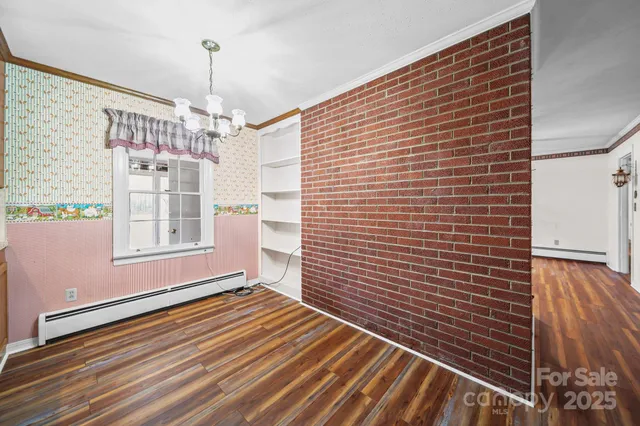 a view of a livingroom with wooden floor and a ceiling fan