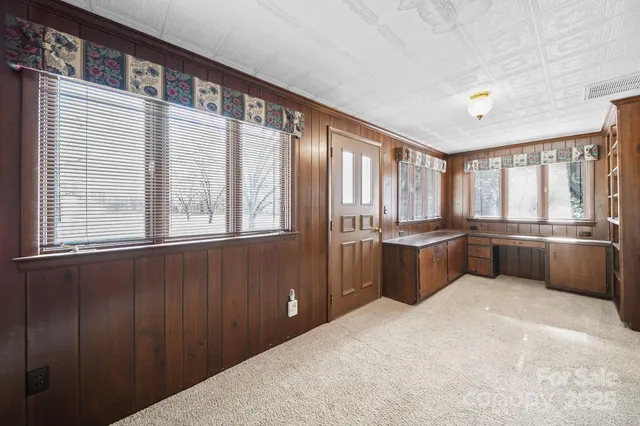 a kitchen with windows and refrigerator