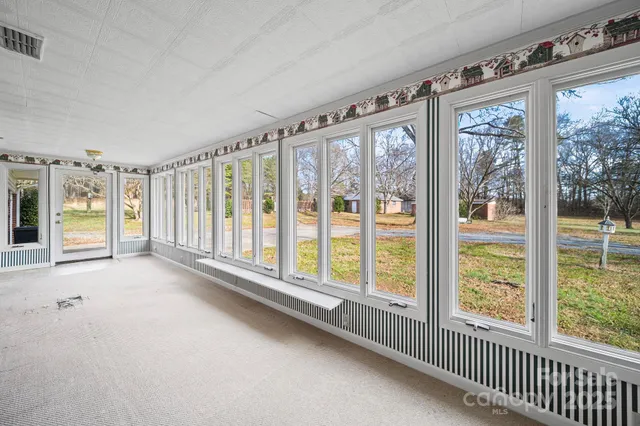 a view of an empty room with windows