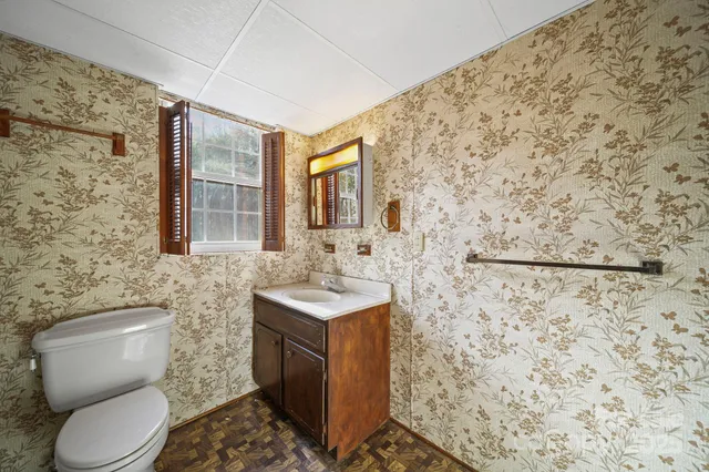a bathroom with a toilet sink and shower