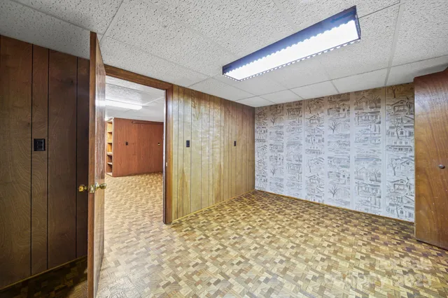a view of a hallway with wooden walls