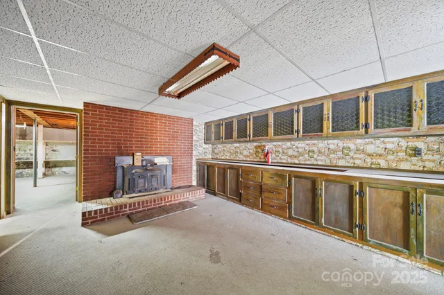a spacious bathroom with stainless steel appliances granite countertop a sink and cabinets