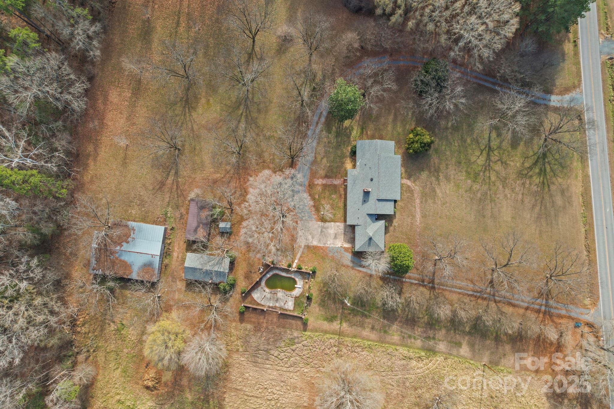 1223 Walker Road Mount Pleasant, NC 28124 - Photo 4 of 48 an aerial view of a house with a yard and wooden fence