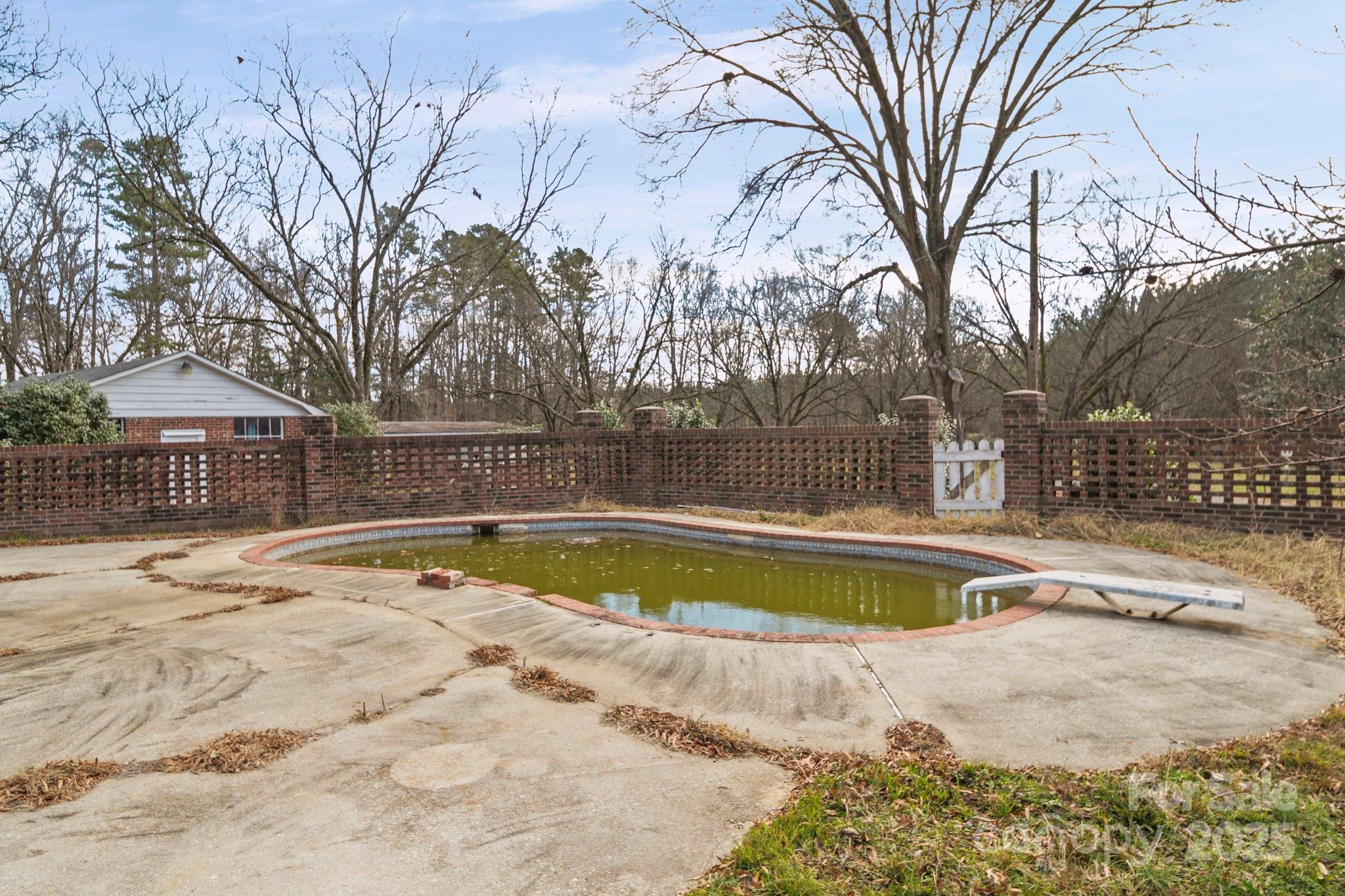 1223 Walker Road Mount Pleasant, NC 28124 - Photo 41 of 48 a view of a swimming pool with a patio and wooden fence