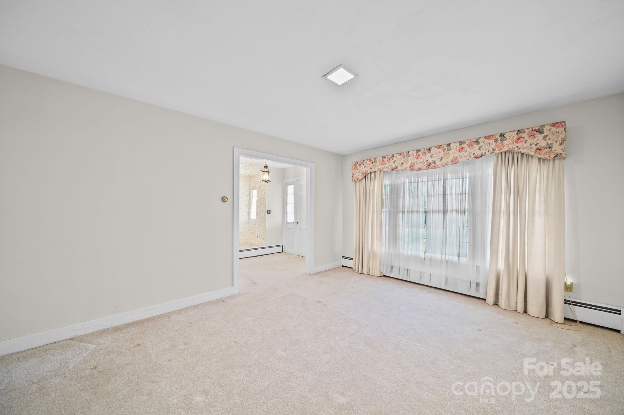 1223 Walker Road Mount Pleasant, NC 28124 - Photo 9 of 48 an empty room with a empty space and a window
