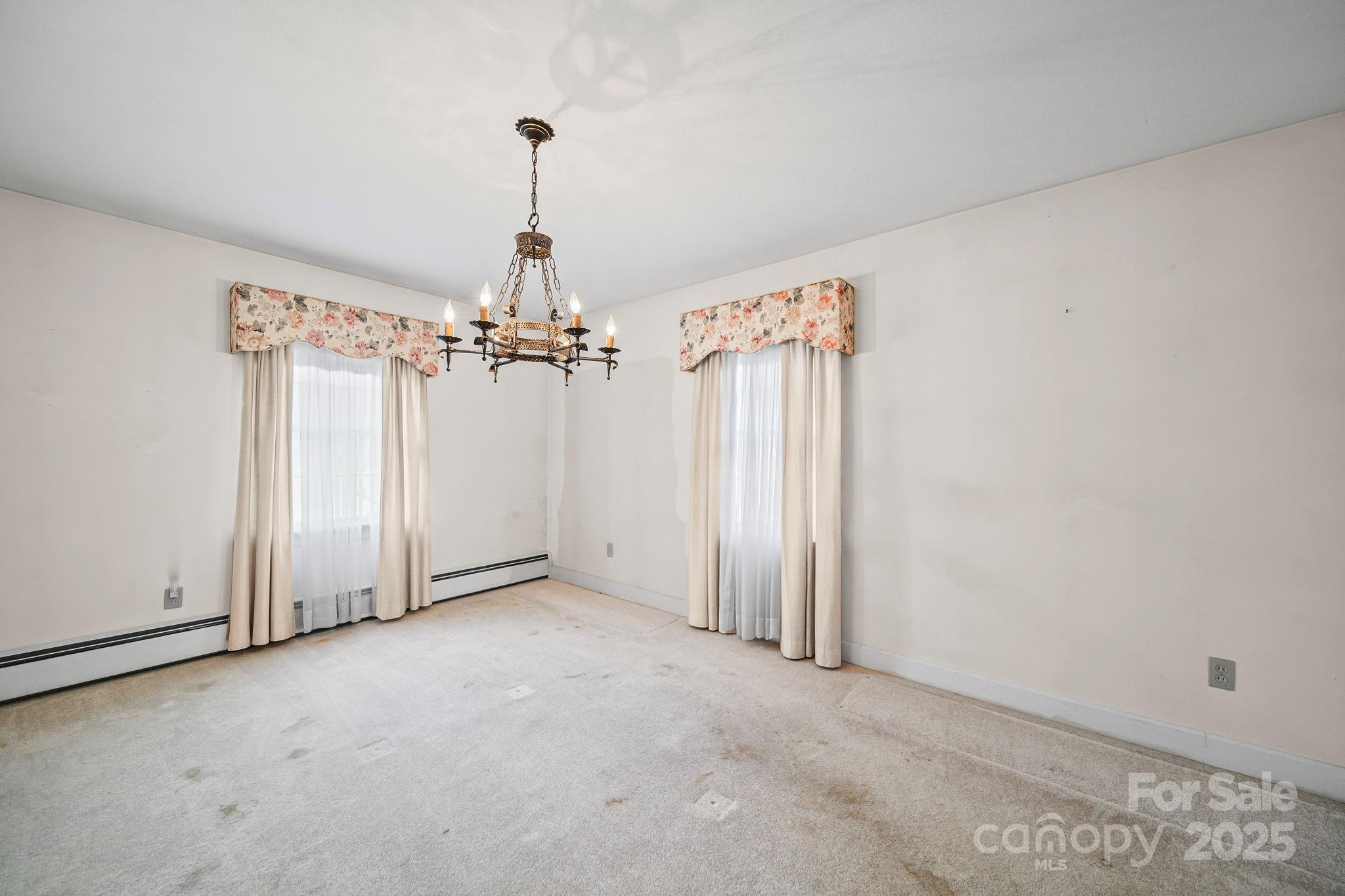 1223 Walker Road Mount Pleasant, NC 28124 - Photo 10 of 48 an empty room with chandelier fan