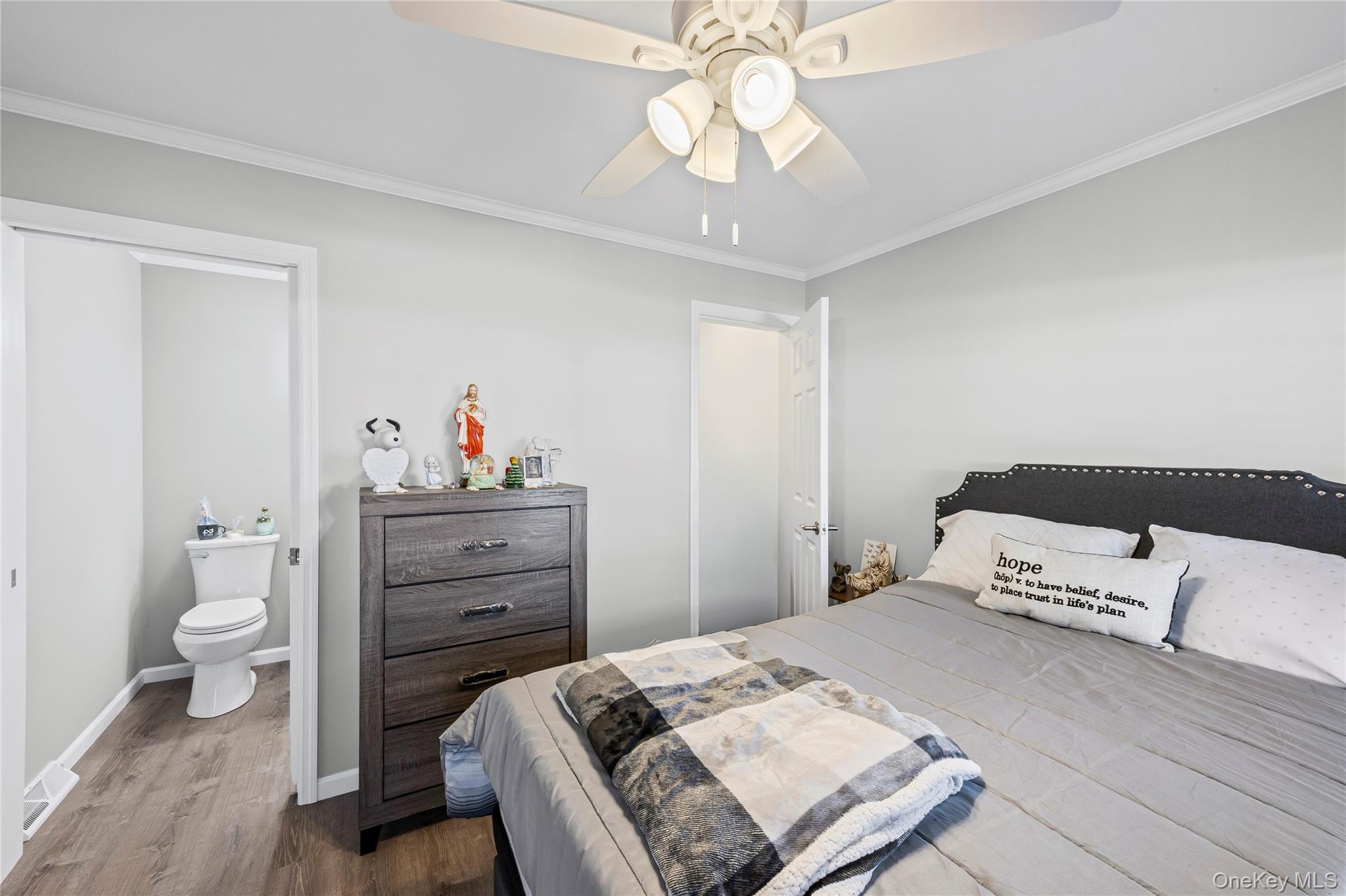 1661 Old Country Road, Unit 351B Riverhead, NY 11901 - Photo 11 of 32 a bedroom with a bed and a chandelier