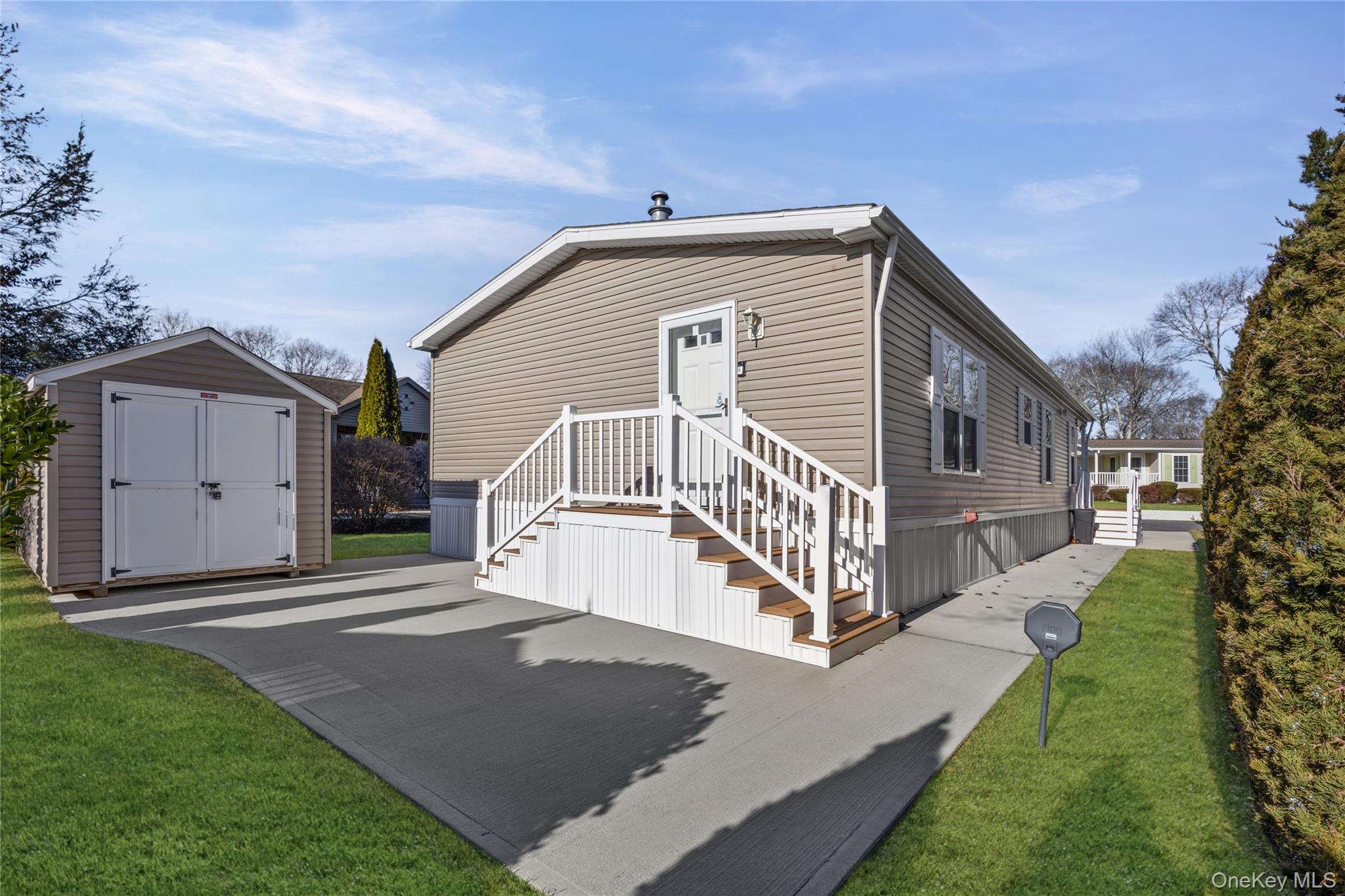 1661 Old Country Road, Unit 351B Riverhead, NY 11901 - Photo 19 of 32 a view of a house with a yard and porch