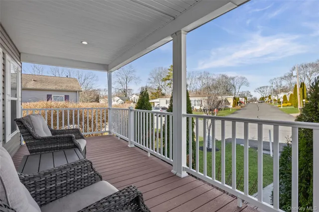 a view of a balcony with wooden floor