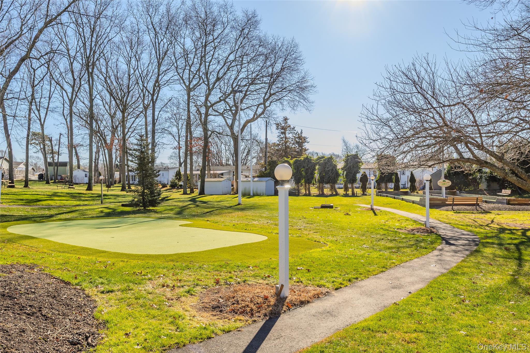 1661 Old Country Road, Unit 351B Riverhead, NY 11901 - Photo 24 of 32 a view of swimming pool with trees