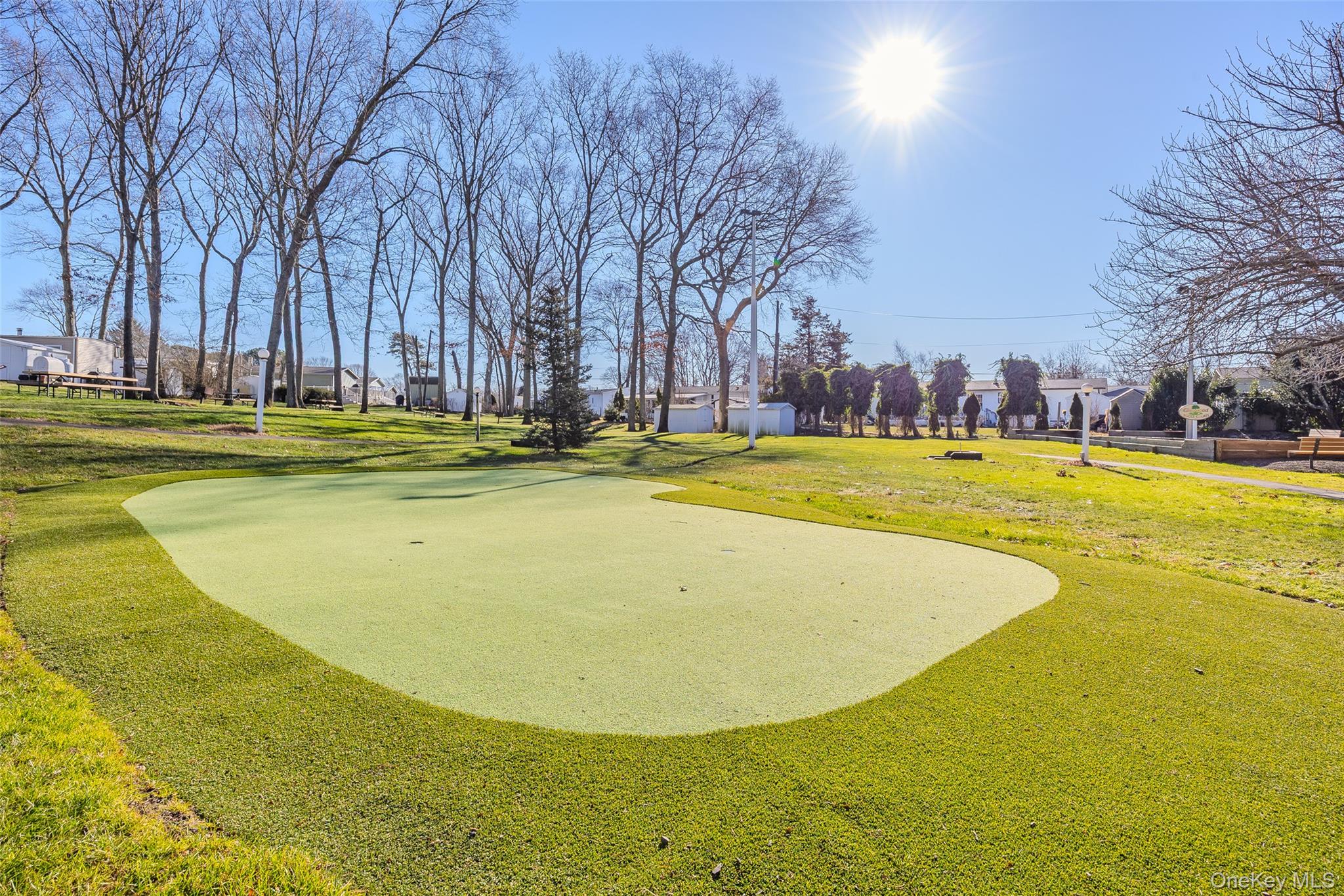 1661 Old Country Road, Unit 351B Riverhead, NY 11901 - Photo 25 of 32 a view of a swimming pool with an outdoor space and seating area