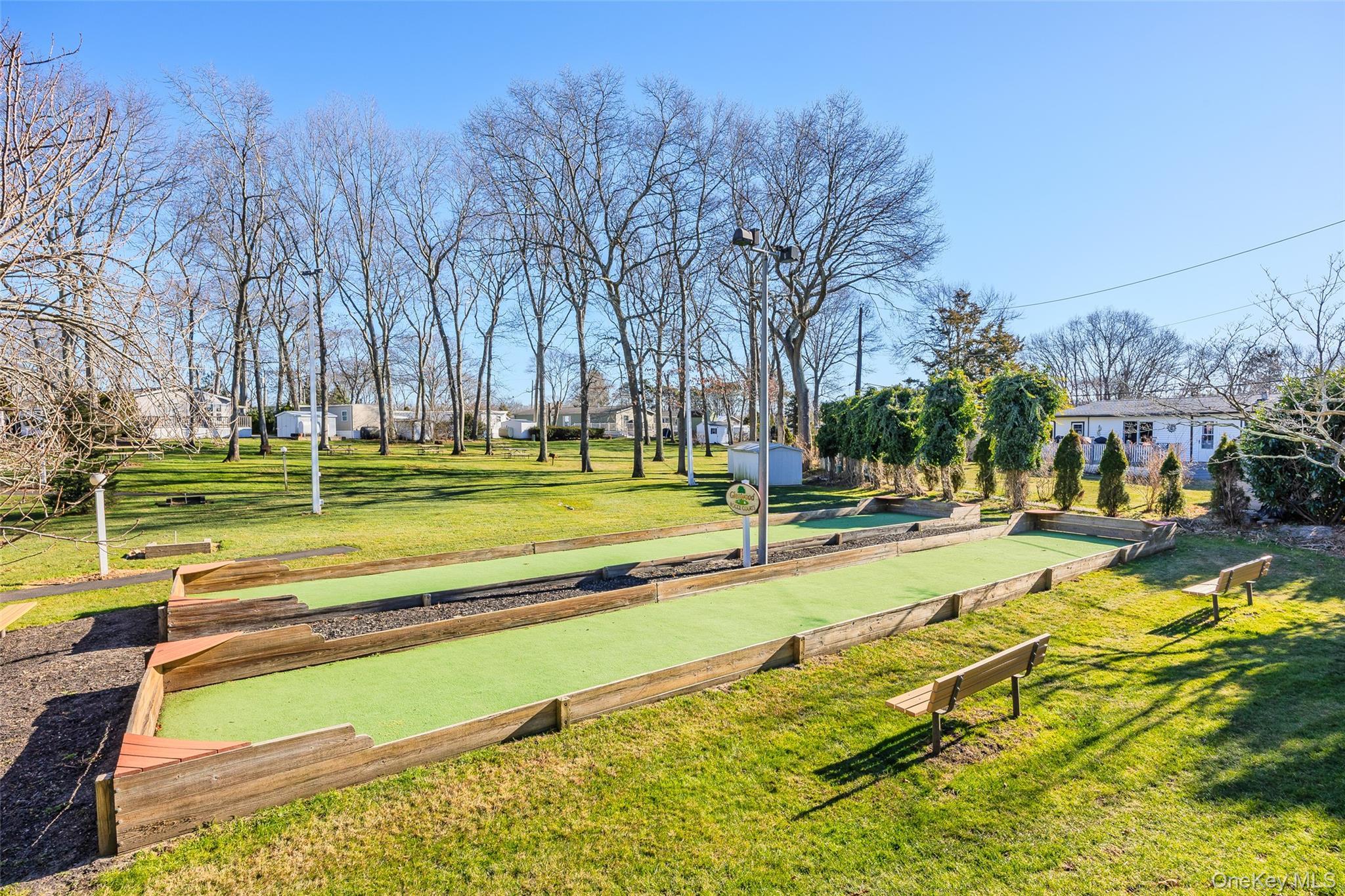 1661 Old Country Road, Unit 351B Riverhead, NY 11901 - Photo 27 of 32 a view of swimming pool with outdoor seating and trees