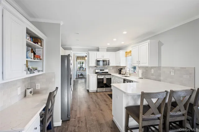 a kitchen with a table chairs refrigerator and cabinets